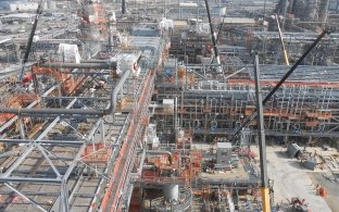 Drone image of the construction with cranes and piping