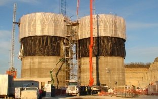 Outdoor image of two tall towers with a ladder leading to the top