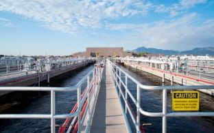 An elevated walkway over the water treatment water holding pool.