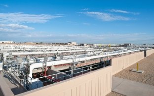 A complex array of white pipe at a water treatment plant.