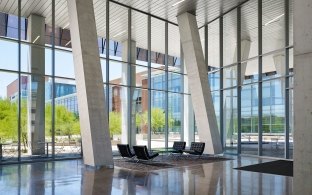 Modern seating in the main atrium inside the glass-walled Biodesign building.