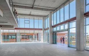 Open lobby area of the building with large glass windows