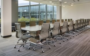 A conference room with a long table surrounded by chairs