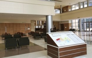 A lobby area with chairs and a large map 