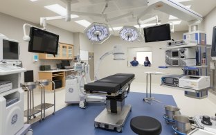 A patient bed surrounded by monitors and equipment