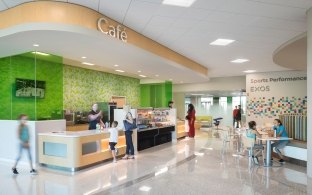 A lobby/front desk area with a bright green wall in the background