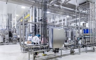 Indoor image of workers working at a station 