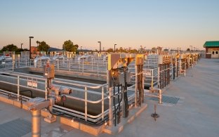 Several rows of water treatment plant pools and tanks.