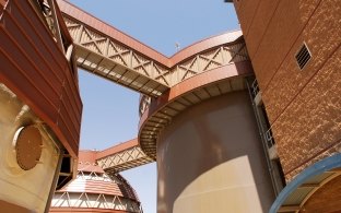 Massive water tanks with covered walkways between tanks.