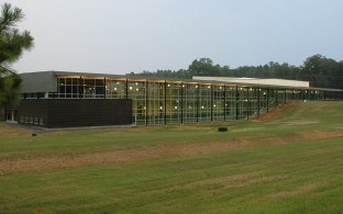 A grassy area with a building in the background