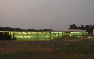 A grassy area with a building in the background