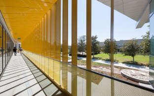 Outdoor hallway that has a yellow ceiling 