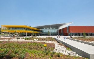 Daylight image of the entrance and landscaping