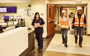 Construction workers and medical staff in a hospital.