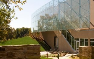 Outdoor image of the enterance with the glass cage and windows