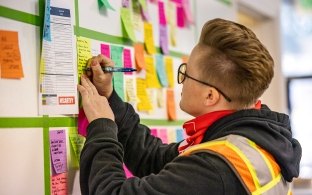 employee writing on post-it note