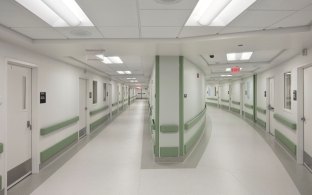 Indoor image of two hallways with patient rooms 