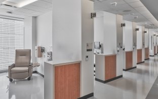 Individual patient treatment areas separated by a wall