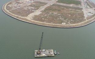 Aerial view of the completed levee stabilization wall surrounded by water