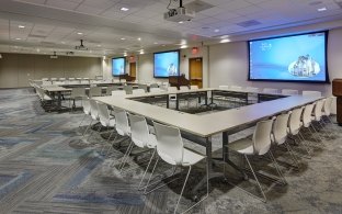 Conference room with large monitors on wall