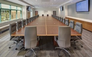 Large conference room table with chairs around it.