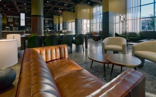 Couch, table chairs and other seating areas in the Nebraska Innovation Campus Scarlet Hotel  lounge