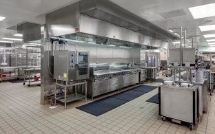 Indoor image of their industrial kitchen with metal counter tops