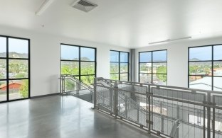 Indoor image of a staircase sounded by windows