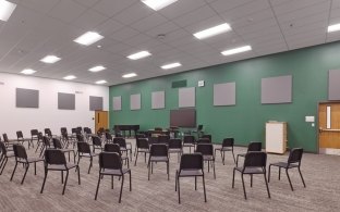 Indoor classroom with overhead lighting and chairs 