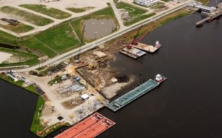 Aerial view of the barge docks during construction with water in the foreground of the photo