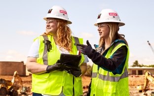 Two construction workers on a jobsite.