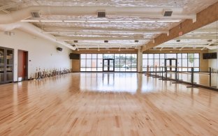 room with hardwood floors and mirrored wall