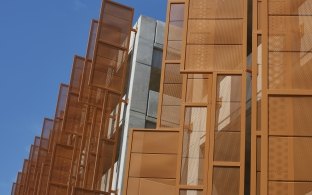 Perforated metal fins sheath portions of the parking structure's exterior