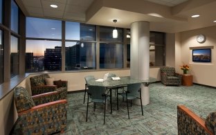 A sitting area with chairs and a table in the middle