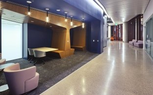 Indoor image of a hallway and reading nook with multiple chairs