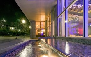 Exterior walkway in front of a row of glass windows