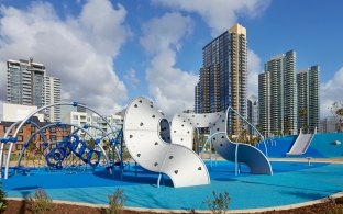 Waterfront Park playground with play equipment and city buildings in background