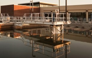 Water and pipes in front of the water treatment plant building