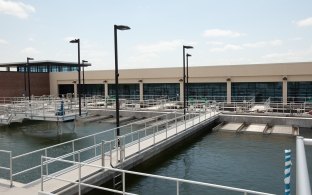 Water and pipes in front of the water treatment plant building