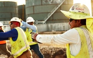 Construction workers stretching on the jobsite.