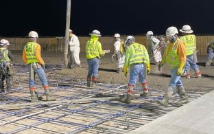 construction workers pouring concrete