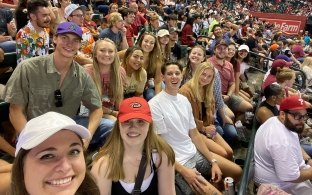 Group of people sitting in the stands at a baseball game
