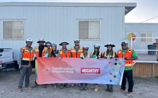Group of people standing at a jobsite with Construction Inclusion Week sign