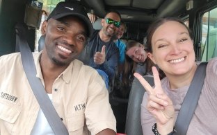 Group of people taking a selfie inside a vehicle