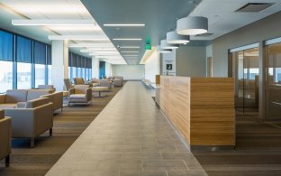 A hospital waiting room with reception area and chairs for patients