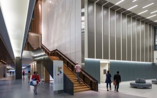 A staircase in a lobby with tall ceilings