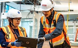 Two people working at a jobsite