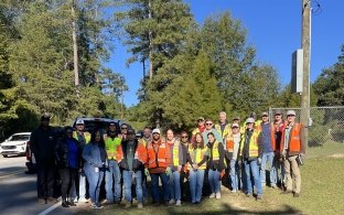 Group of people standing together at a community volunteer event.