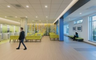A person walking through a lobby area that has a seating area