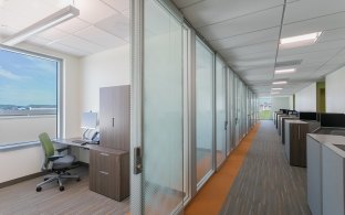 An office area with private offices and cubicles.